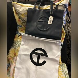 Medium navy blue Telfar shopping bag with dust bag